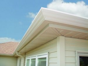 Eaves of off-white home with steel soffit and fascia.