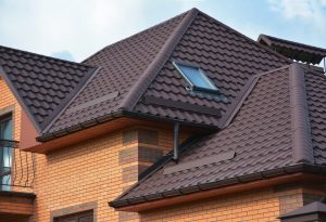 A brown tile-style metal roof on a brick suburban home