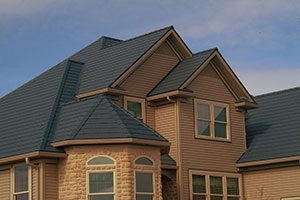 A metal roofing system on a brown suburban home