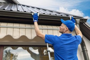 Technician performing gutter replacement 