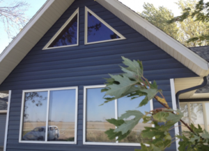 Blue home facade with new vinyl windows