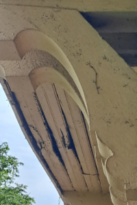 heavily damaged wooden soffit and fascia