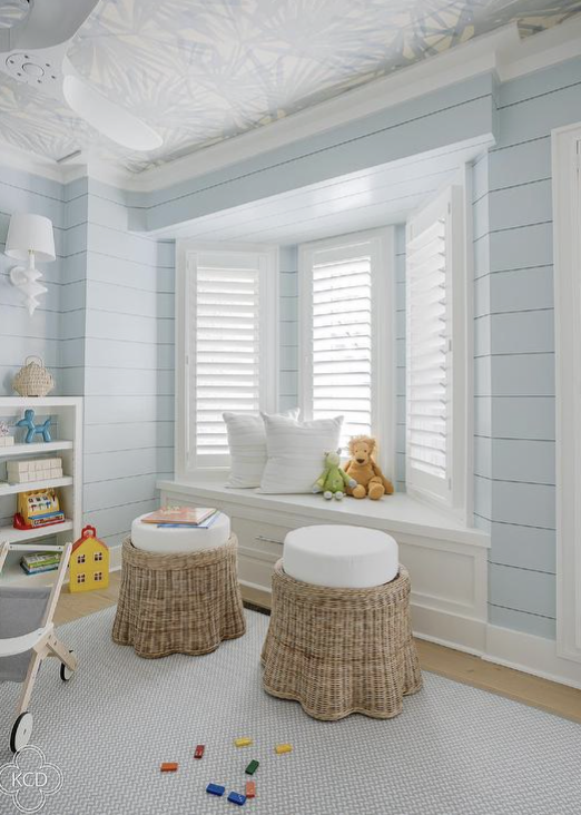 children's room with a bench by a bright bay window