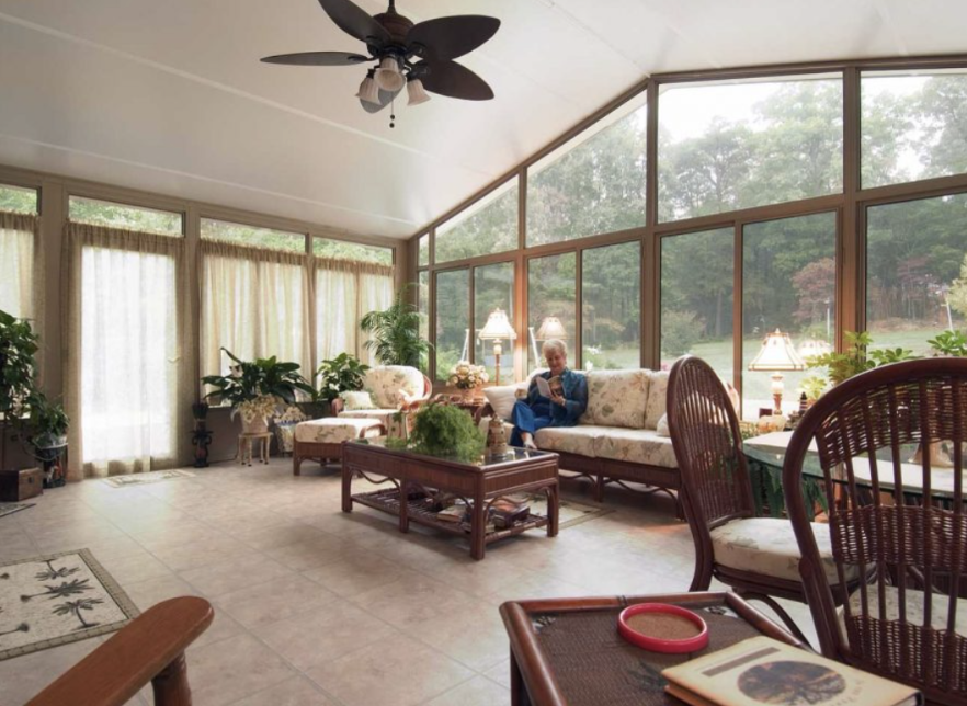 cathedral style sunroom with dining and lounging area