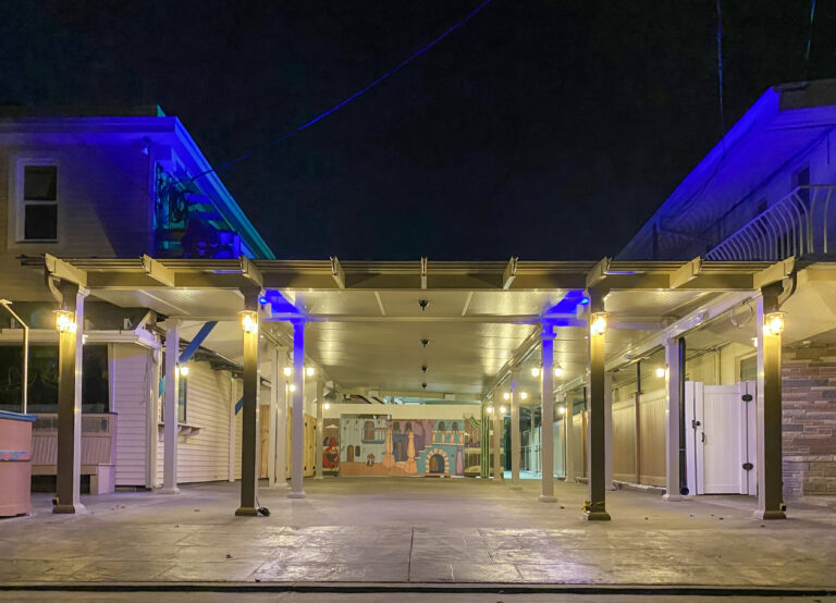 night view of high-tech patio cover with LED lighting in blue