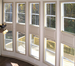 Elegant bow windows providing view of outdoor porch.